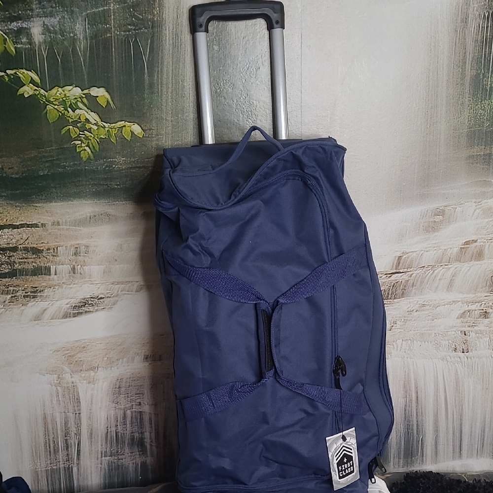 New with tags! First Class 26" blue rolling travel duffle bag on wheels
